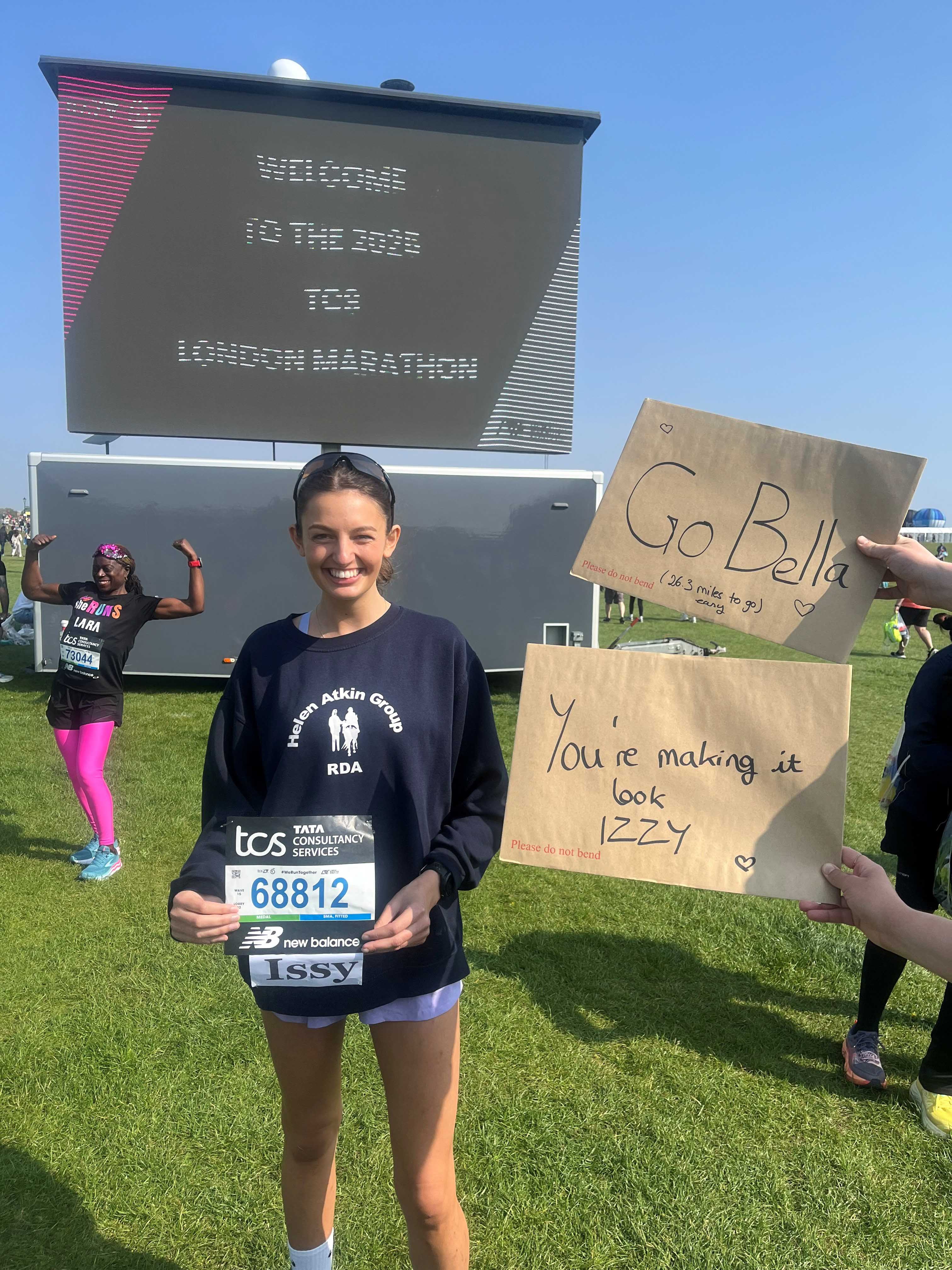 Issy holding her marathon number