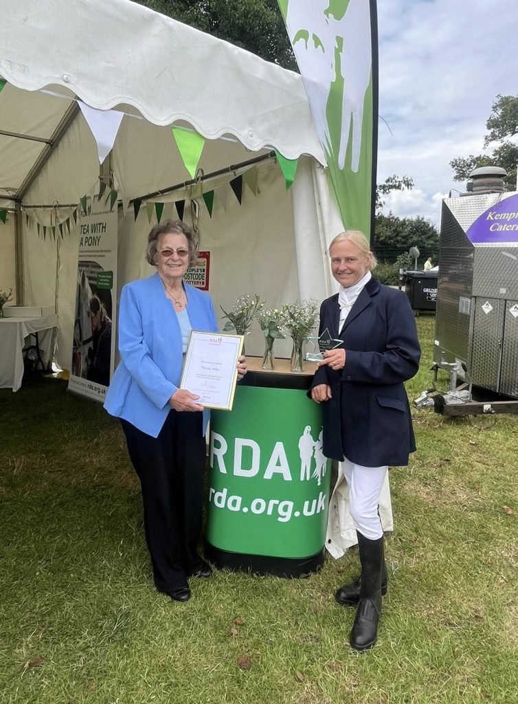 two people displaying an award